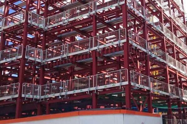 Red steel foundations of half built large building