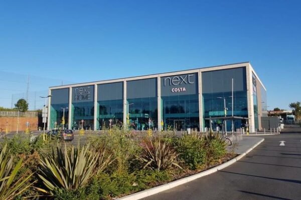 Next and Costa large glass building exterior