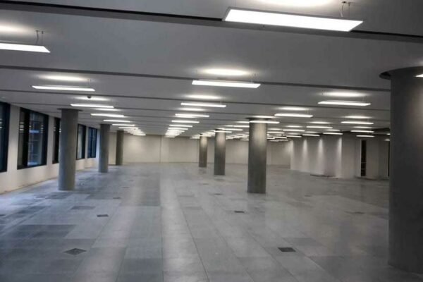 large stripped out interior with concrete pillars