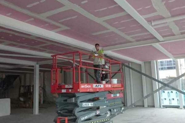 Interior building site with a large electric scissor lift