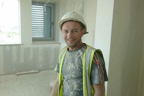 Man in work wear in a building site