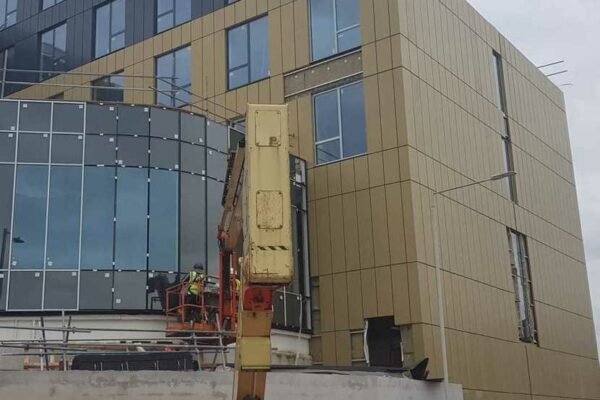 Large modern building as a building site with crane