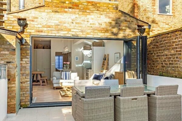 Large french doors leading to a kitchen