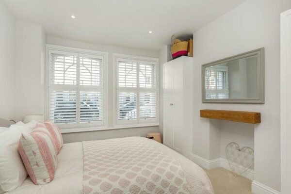 Modern clean white and pink bedroom