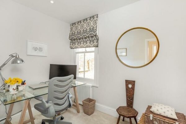 Office in a house with a desk, computer on a desk