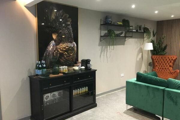 Modern residential living room with green sofas