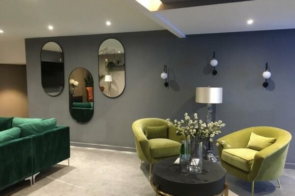 Modern residential living room with green sofas