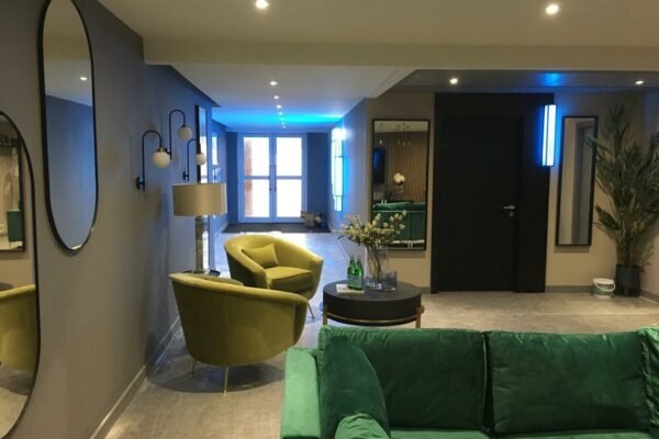 Modern residential room with green sofas